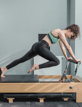 A woman performing a Pilates workout