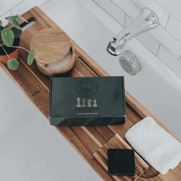 The recovery gift set from Unplugged Essentials atop a bath caddy