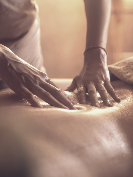 A gentleman receiving a deep tissue massage on his lower back.
